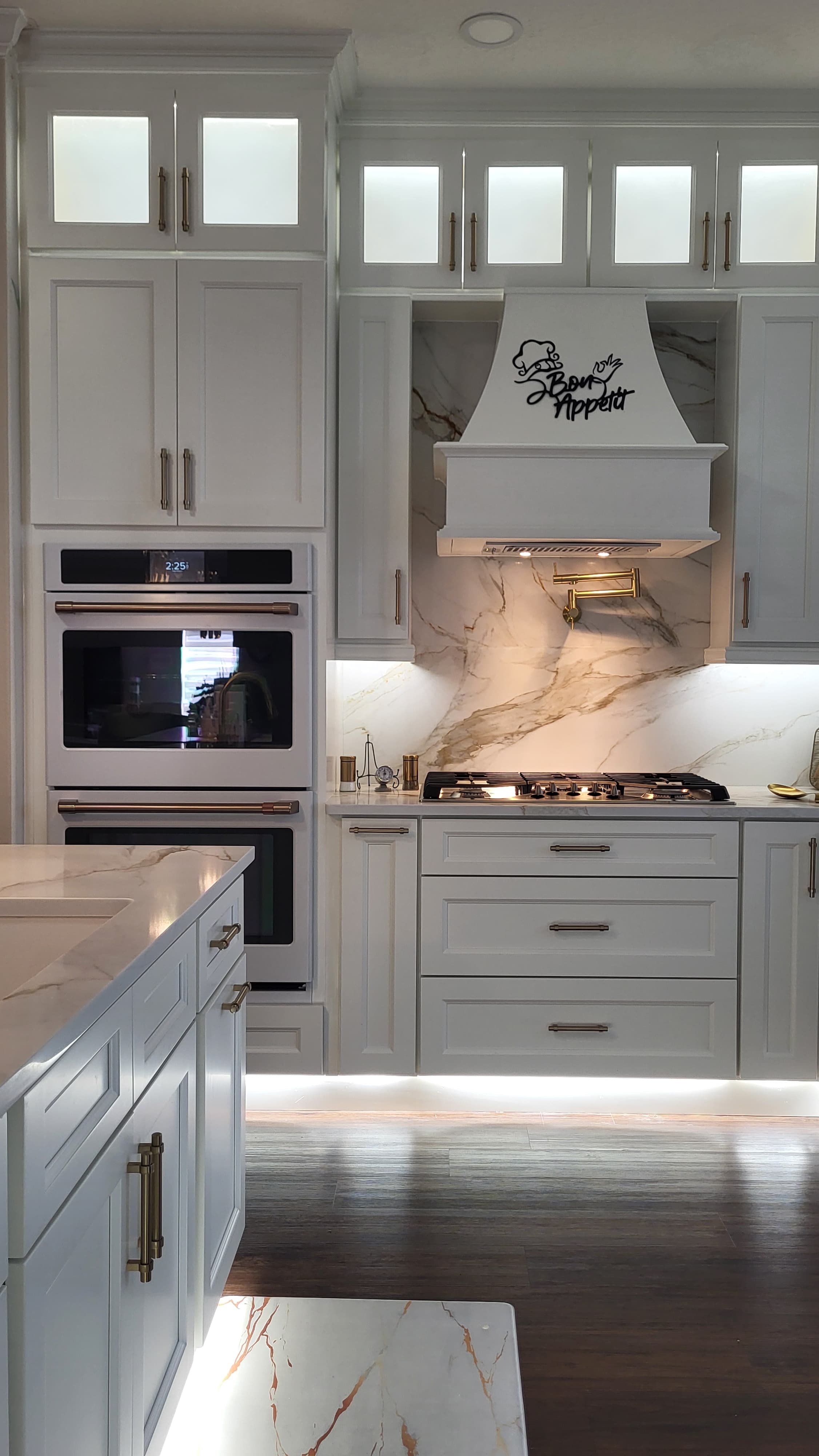 Marble and brass kitchen with hood