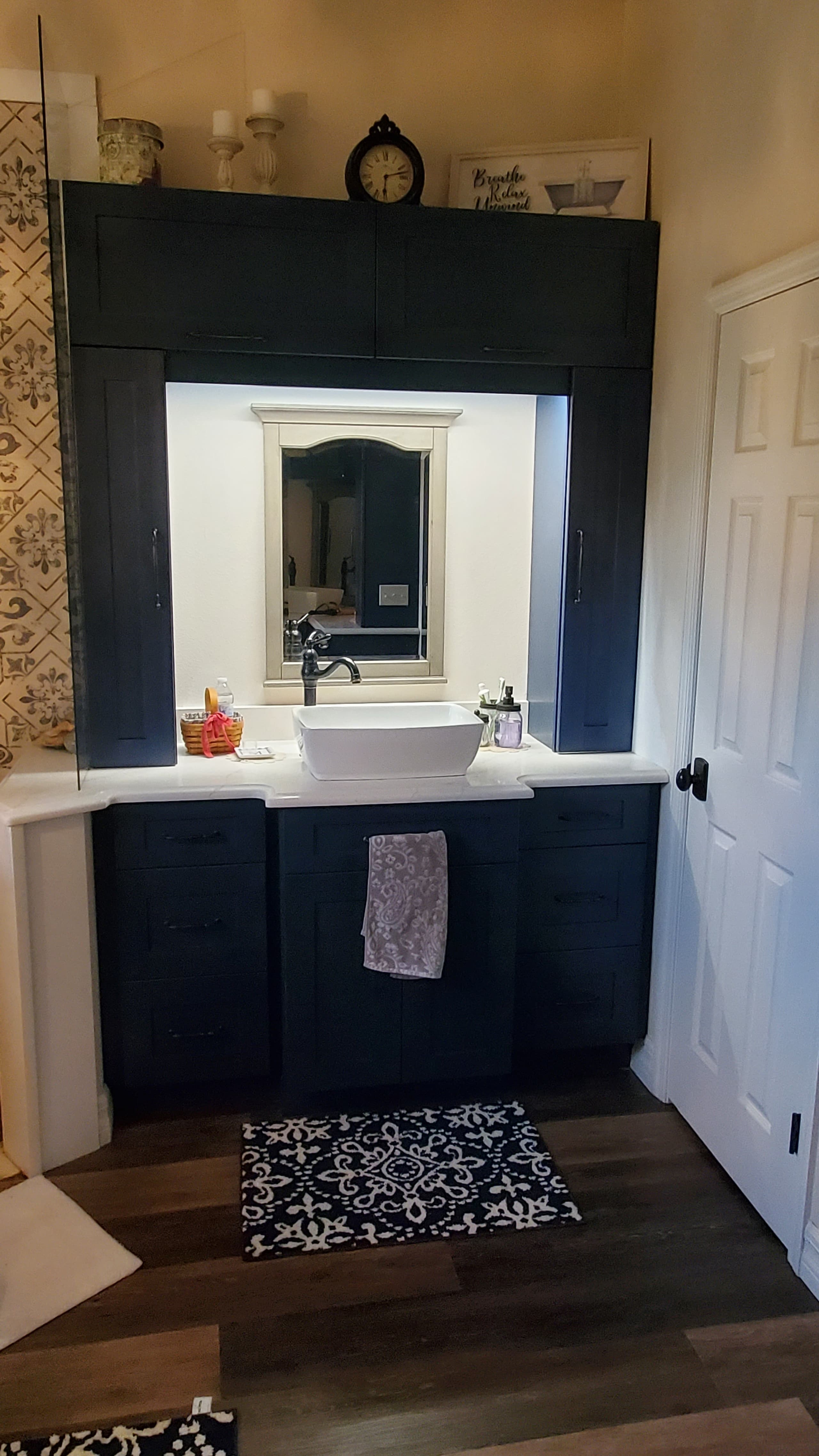 Navy shaker vanity with vessel sink and decorative tile